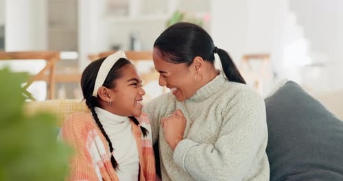 Mother and Daughter Laughing Together at Home