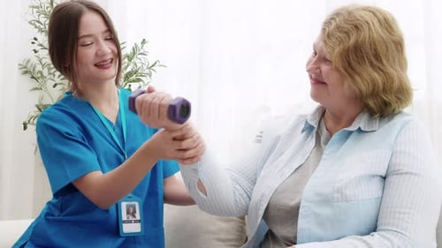 Senior Woman Exercises with Medical Professional at Home