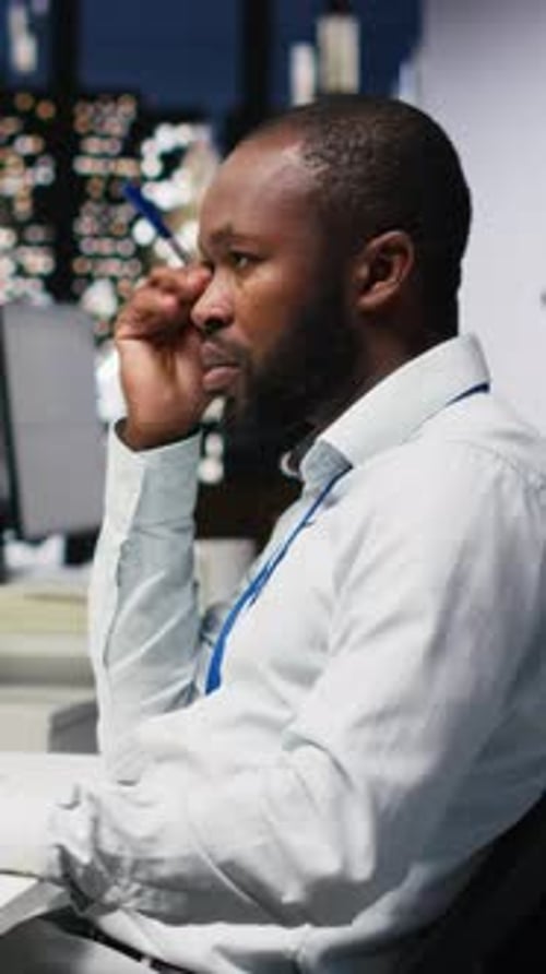 Man Working Late at Office, Thinking Deeply