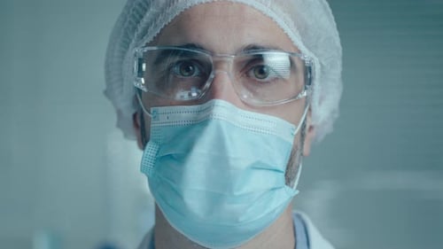 Doctor with mask and glasses close up