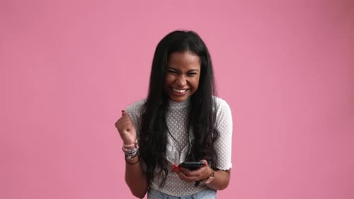 Excited Woman Celebrates Good News on Phone