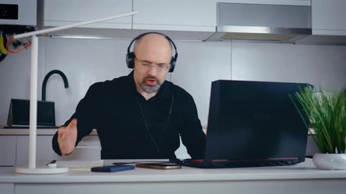 Man Engaged in Video Call at Home Office