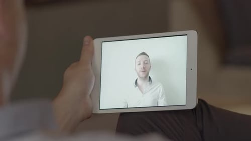 Man on Tablet During Video Conference Call