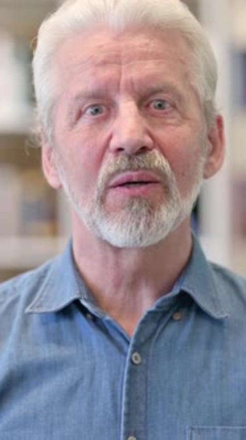 Smiling Senior Man Talking and Waving Hello