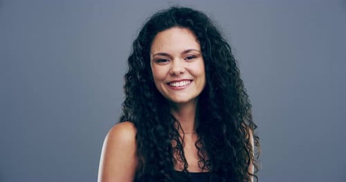 Smiling Woman Makes Heart Shape with Hands