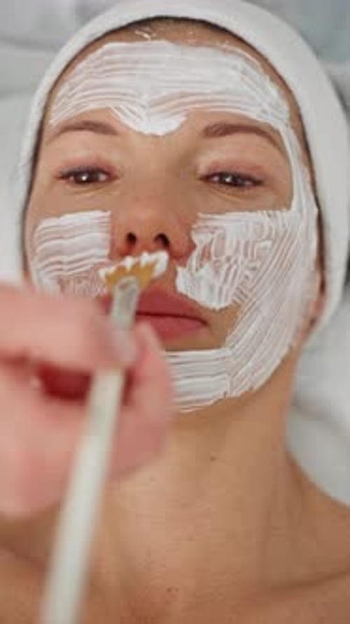 Woman Receiving Facial Beauty Mask Treatment