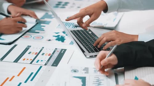 Team Collaboration Analyzing Data and Charts in Workplace