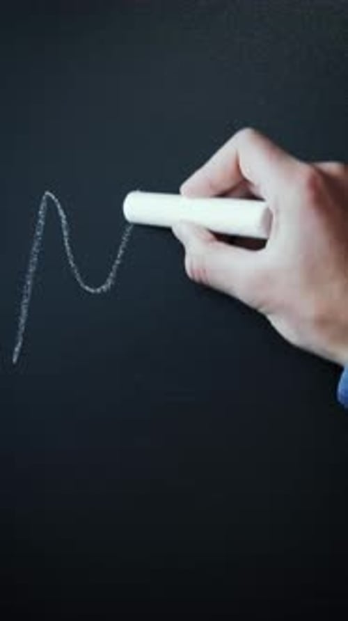 Hand Writes "MENU" on Black Surface