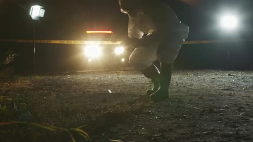 Forensic Investigator Photographs Crime Scene at Night
