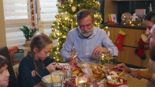 Family Gathered around Table for Christmas Dinner