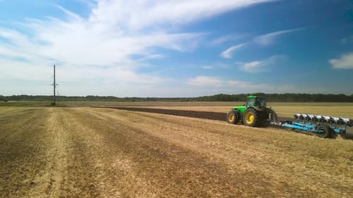 Tractors plowing the field in Ukraine