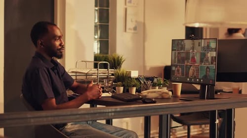 Man Attends Virtual Meeting in a Modern Office