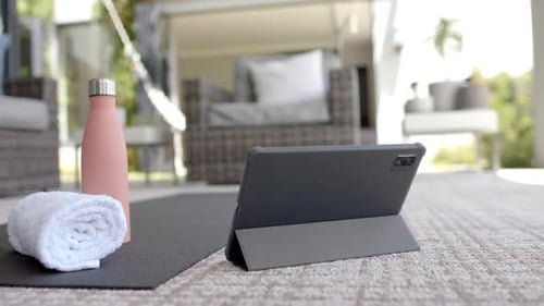 Yoga Mat, Tablet, and Water Bottle on Patio