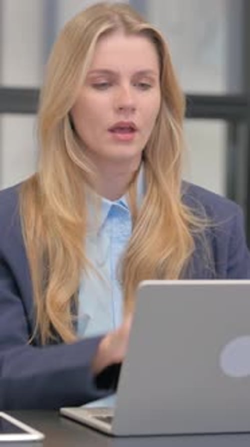 Woman Coughing While Working at Her Laptop