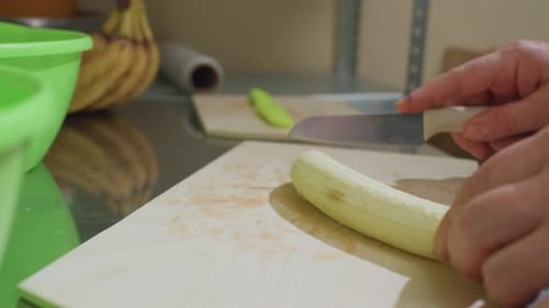 Preparing Food: Close-Up of Cutting Banana on Board