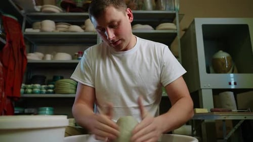 Crop of Unknown Man Artisan in Pottery Workshop Making Clay Pot on Rotary Machine