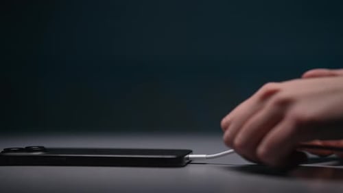 New Mobile Phone Charging on Table Female Hand Disconnecting Unplug Cable From Smartphone Girl