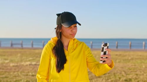 Teenager, girl and phone selfie on beach holiday for social media update with peace sign and smile