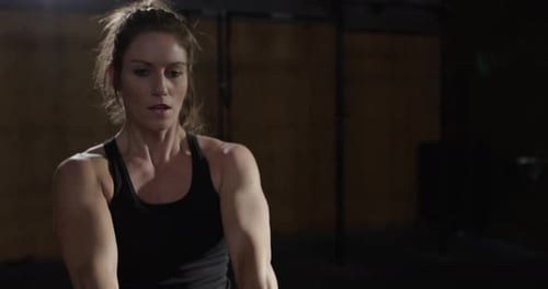 Extreme athletics - Female athlete swinging kettle bells slow motion