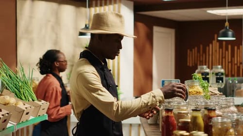 Local Farmer Arranging Eco Friendly Merchandise at Supermarket