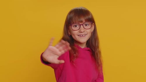 Young Toddler School Girl Kid Smiling Friendly Gesturing Hello or Goodbye Welcoming Waving Hands
