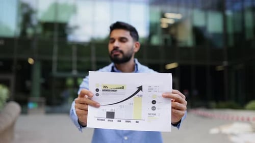 Man Presents Business Growth Chart Outdoors
