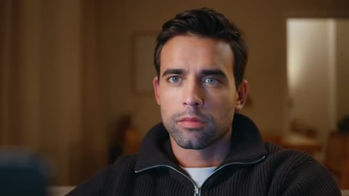 Intense Young Adult Man Watching a Screen