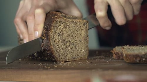 Dark Rye Bread Sliced on Wooden Cutting Board