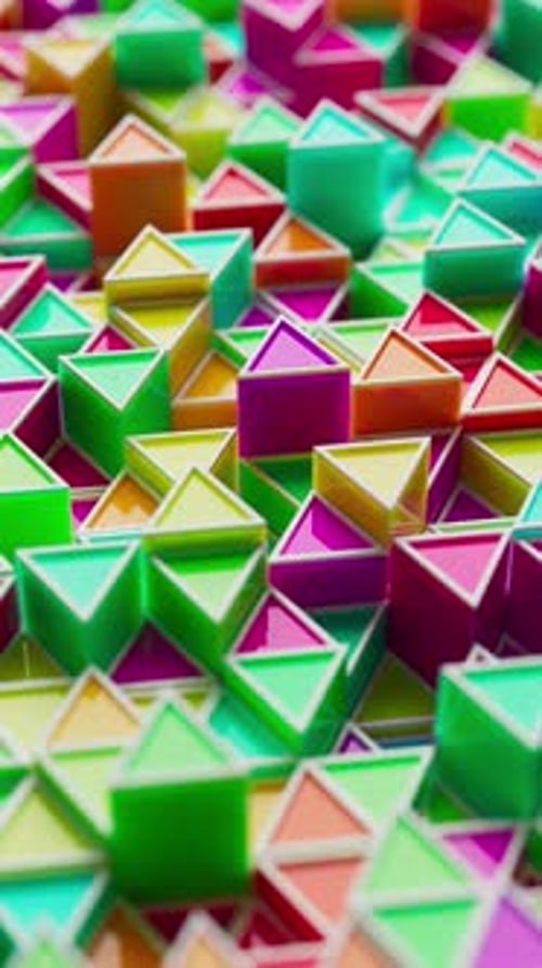 Looped 3D animation of colorful glossy triangles.