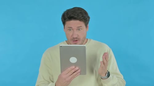 Man Uses Tablet For Video Conference or Call