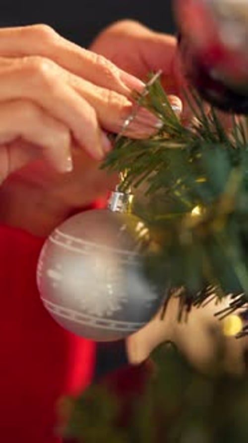Christmas tree, decoration and hands of woman in home for festive celebration or tradition