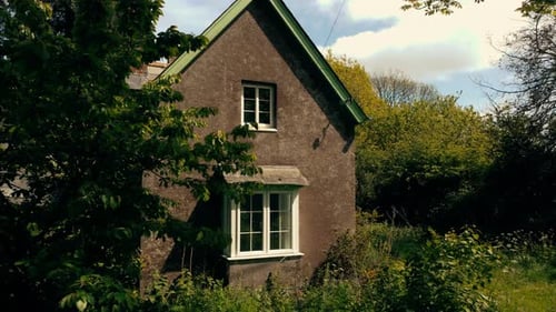 Old Cottage House Surrounded by Trees on Sunny Day