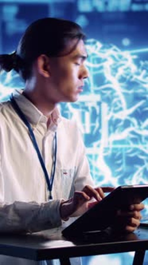 Man Using Tablet with Brain Graphic Background