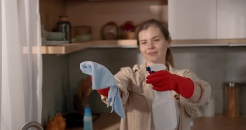 Woman Cleaning Kitchen with Spray Bottle and Rag