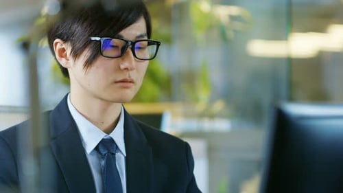 Focused young man working in modern office