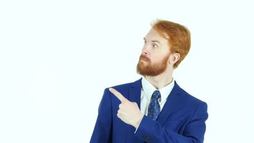 Red-haired Man in Suit Points to Upper Left