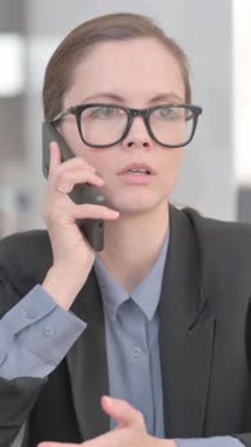 Businesswoman Talking on Phone in Office Setting