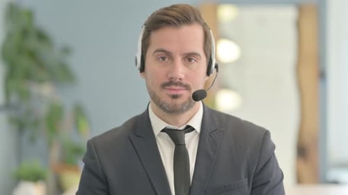 Man with Headset Looks at the Camera