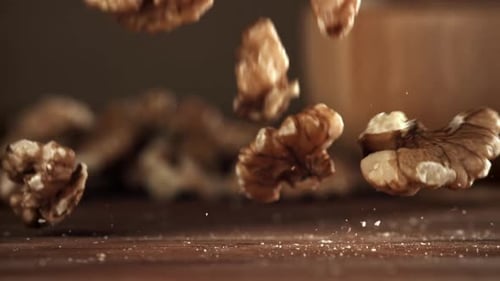 Slow Motion Walnuts Falling on Wooden Table