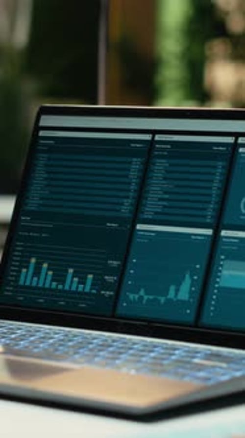 Vertical Video Modern Laptop Showcasing Data Reports in an Empty Office Late at Night