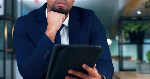 Man in Suit Working on Tablet in Office