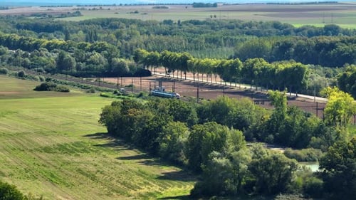 Railway in the Countryside and Trains Passing Aerial View Beautiful Green Scenery in France Nature