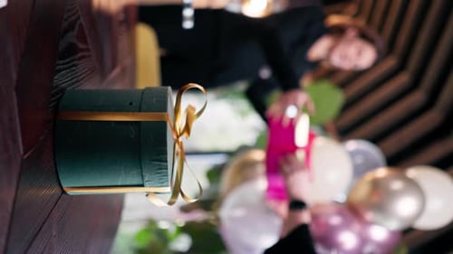 vertical video close-up of a beautiful gift box standing on a table in a restaurant a celebration