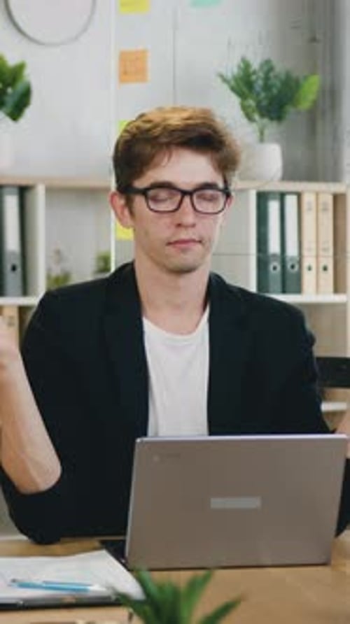 Office Work Concept Where Man Programmer in Glasses Sitting with Closed Eyes at the Desk During