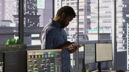 Man Walking with Tablet in Office Fixing Coding Issues