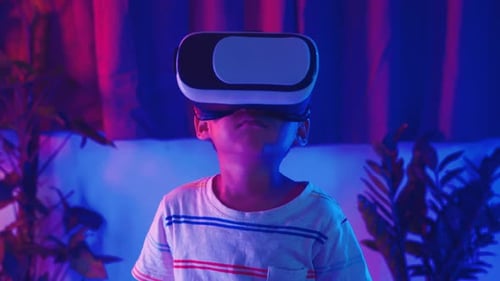 Child Wearing VR Headset in Neon-Lit Room