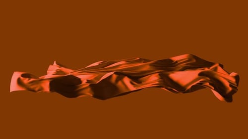 Red silk fabric flowing on brown background