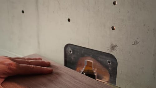 Machinist at Work Performing Tasks on Wood Shaper Close Up