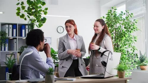 Positive Atmosphere in Office Young Black Man Having Fun with Female Colleagues During Coffee Break