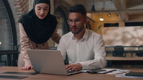 Muslim Business Team in Office Two Partners Man and Woman Looking Laptop Talking Arabian Man